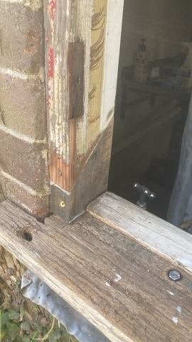 Close-up of the deteriorated timber window frame